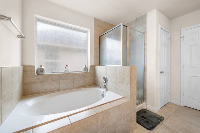 bathroom featuring tile patterned flooring, plus walk in shower, and a wealth of natural light