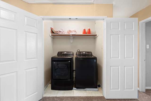 laundry area featuring washer and dryer and light carpet