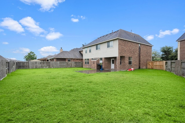 rear view of property featuring a lawn