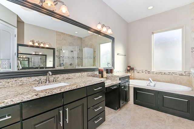 bathroom featuring tile patterned flooring, shower with separate bathtub, vanity, and plenty of natural light