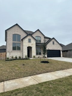 french country inspired facade featuring a garage and a front yard