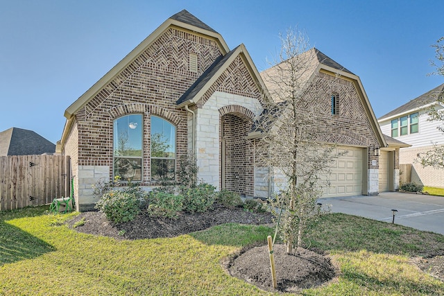 view of front of property with a garage and a front yard