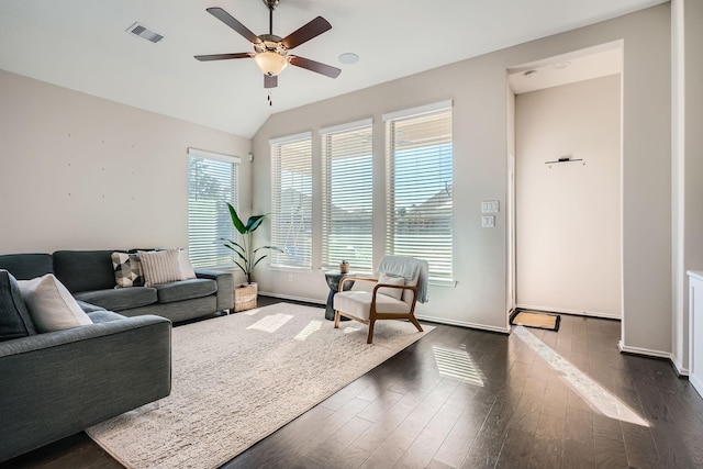 living room featuring ceiling fan, dark hardwood / wood-style floors, and vaulted ceiling