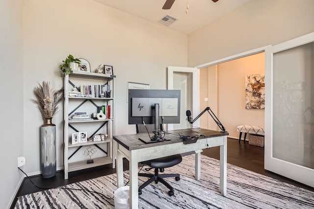 home office featuring ceiling fan and dark wood-type flooring