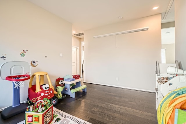 playroom featuring dark wood-type flooring