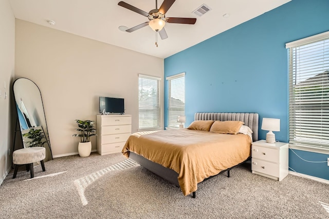 bedroom featuring ceiling fan and carpet