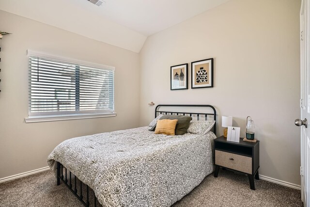 bedroom with carpet flooring and vaulted ceiling