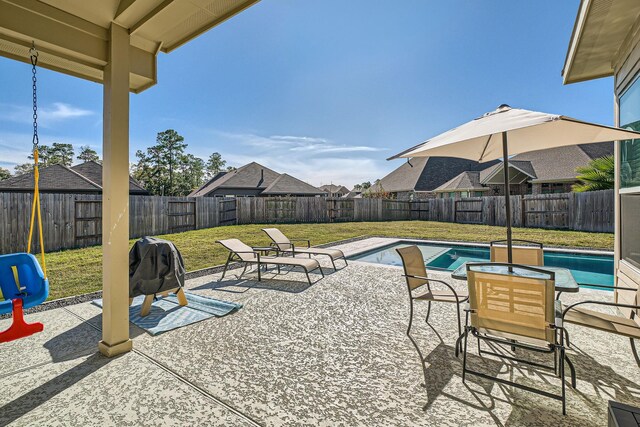 view of swimming pool featuring a lawn and a patio area