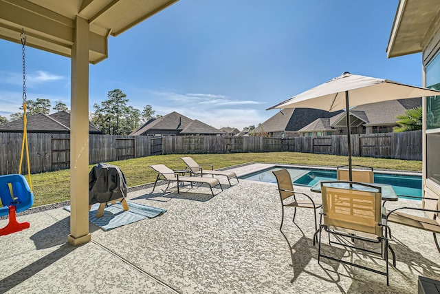 view of pool with a patio and a yard