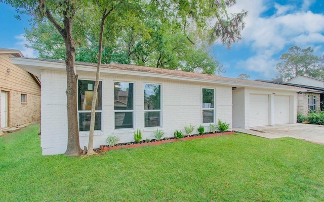 ranch-style home featuring a garage and a front yard