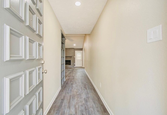 corridor with light hardwood / wood-style flooring