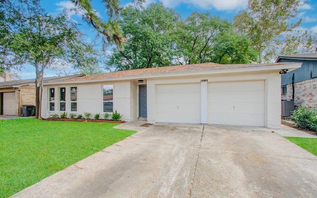 ranch-style home featuring central AC unit, a front lawn, and a garage