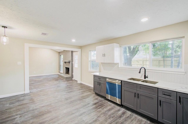 kitchen featuring white cabinets, dishwasher, decorative light fixtures, sink, and gray cabinets