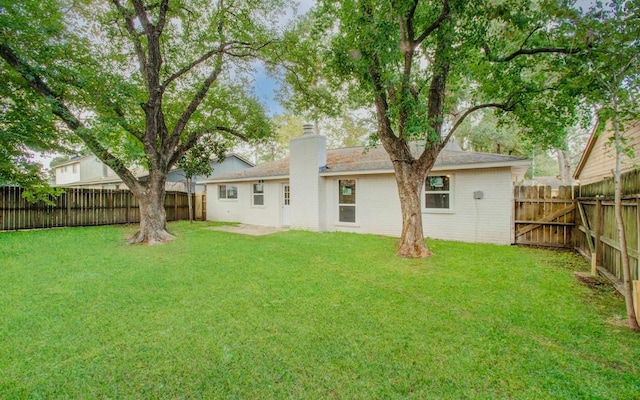 rear view of property featuring a yard