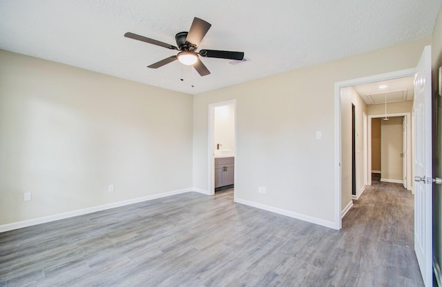 unfurnished room with ceiling fan, a textured ceiling, and light hardwood / wood-style floors