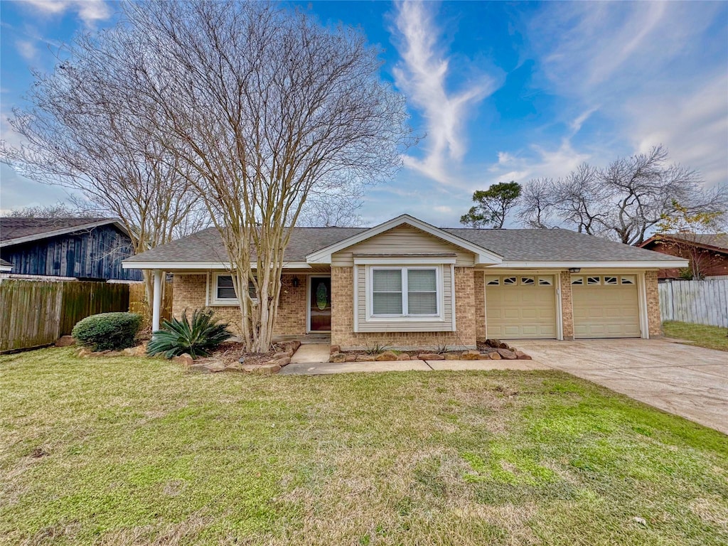 ranch-style house featuring a front yard and a garage