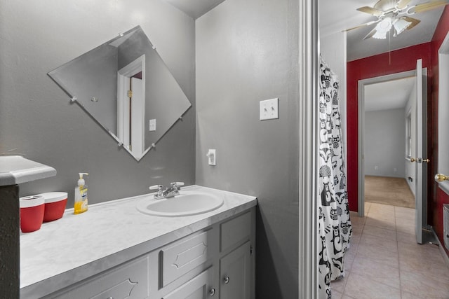 bathroom with tile patterned floors, vanity, and ceiling fan