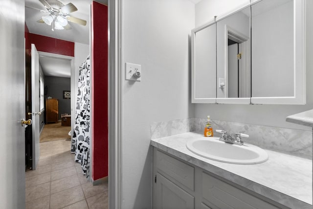 bathroom with tile patterned flooring, vanity, and ceiling fan