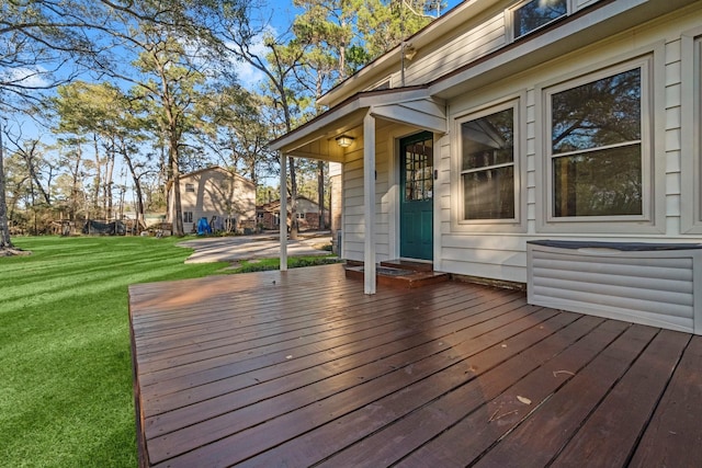 wooden deck with a lawn