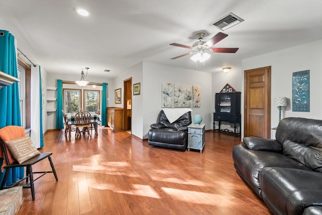 living room featuring hardwood / wood-style floors and ceiling fan