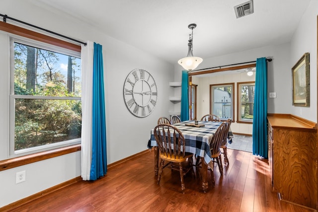 dining area with dark wood-type flooring