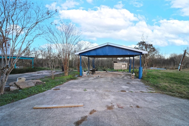 view of vehicle parking with a lawn