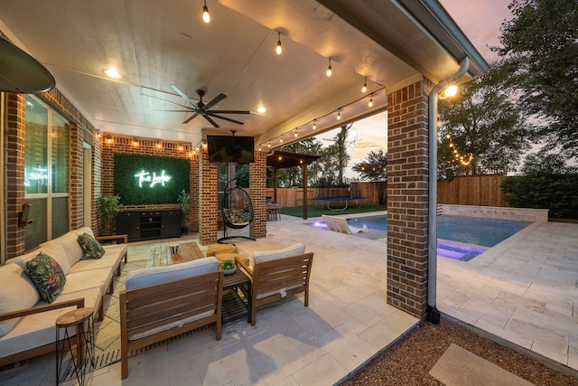 patio terrace at dusk with a fenced in pool, ceiling fan, an outdoor hangout area, and a trampoline