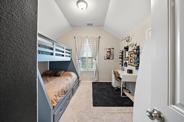 carpeted bedroom with lofted ceiling