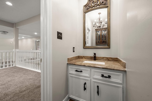 bathroom with a chandelier and vanity