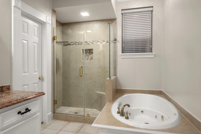 bathroom featuring shower with separate bathtub, tile patterned floors, and vanity