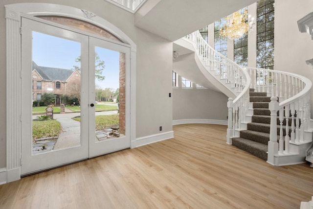 entryway featuring a wealth of natural light, french doors, and a chandelier