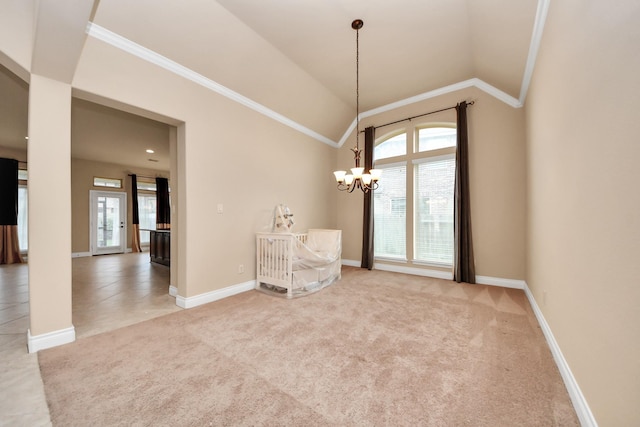 carpeted spare room featuring lofted ceiling, crown molding, and an inviting chandelier