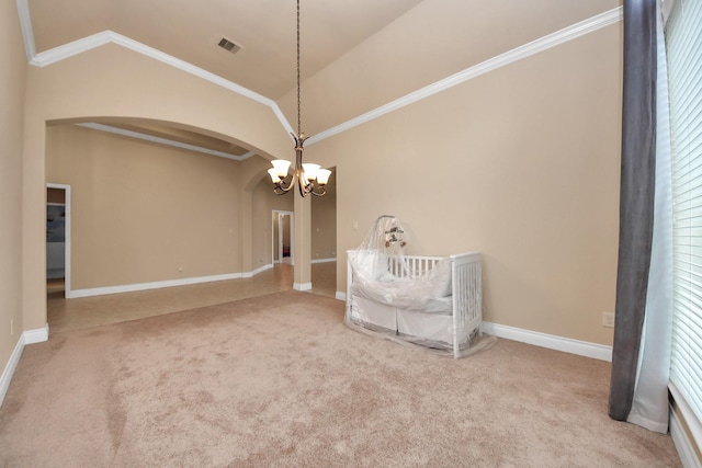 unfurnished bedroom featuring carpet, ornamental molding, vaulted ceiling, and a notable chandelier