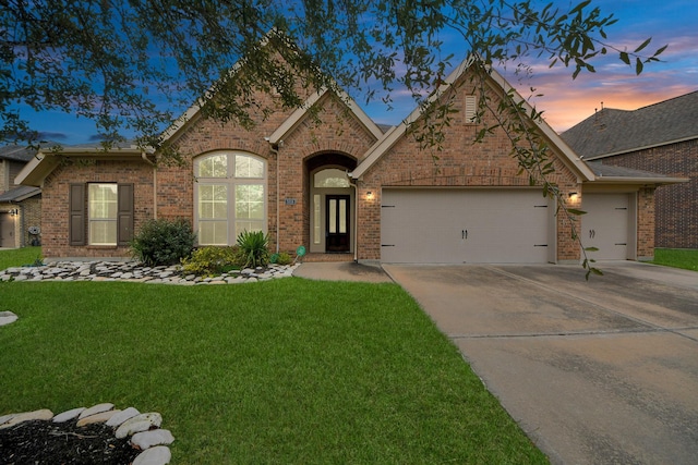 view of front facade with a lawn and a garage