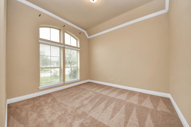 carpeted empty room with vaulted ceiling and ornamental molding