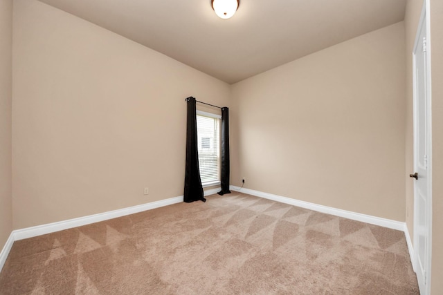 spare room featuring light colored carpet