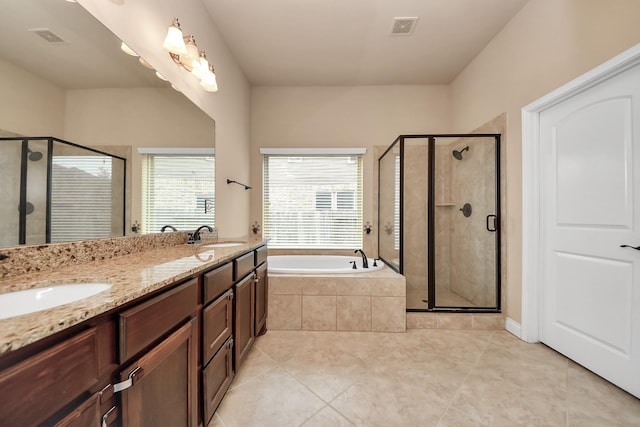 bathroom with tile patterned flooring, vanity, and separate shower and tub