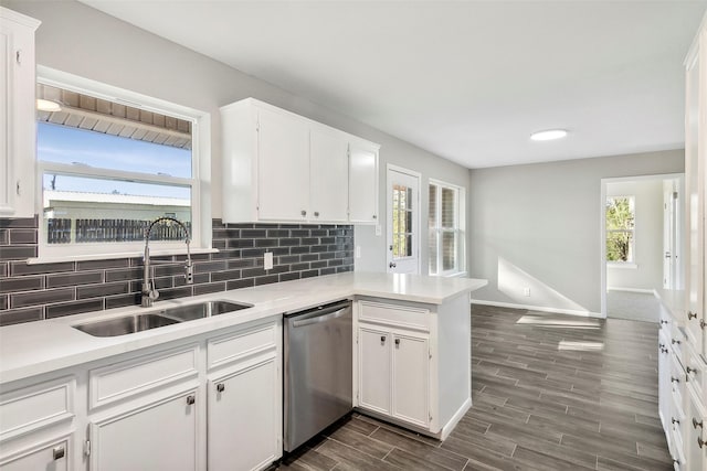 kitchen featuring a wealth of natural light, sink, white cabinets, and stainless steel dishwasher