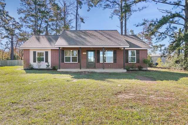 rear view of property featuring a lawn