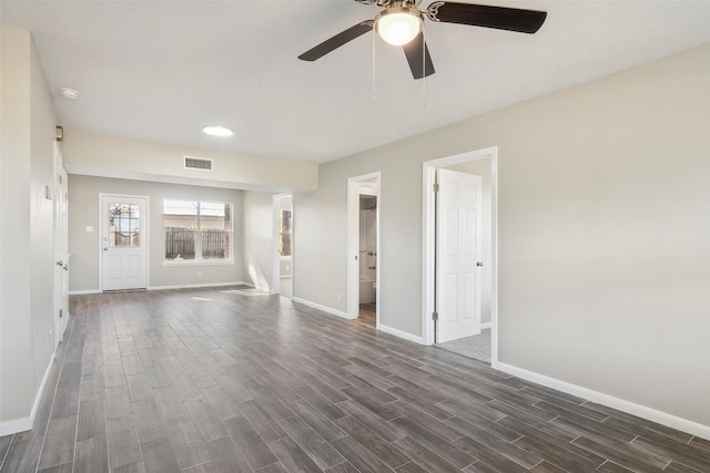 unfurnished living room with ceiling fan and dark wood-type flooring