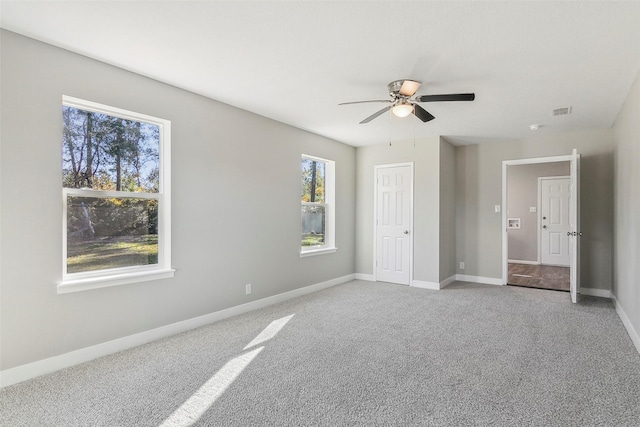 unfurnished bedroom with ceiling fan and carpet