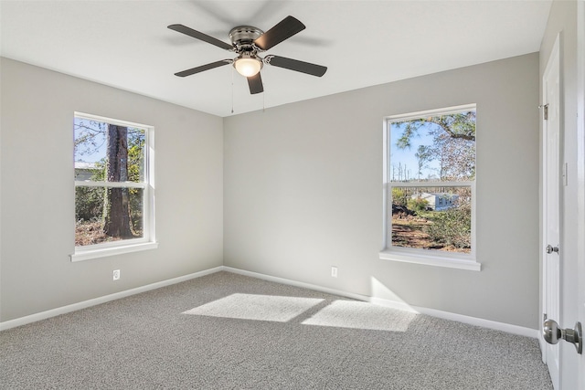 carpeted spare room with ceiling fan