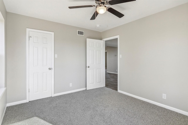 unfurnished bedroom featuring ceiling fan and carpet floors