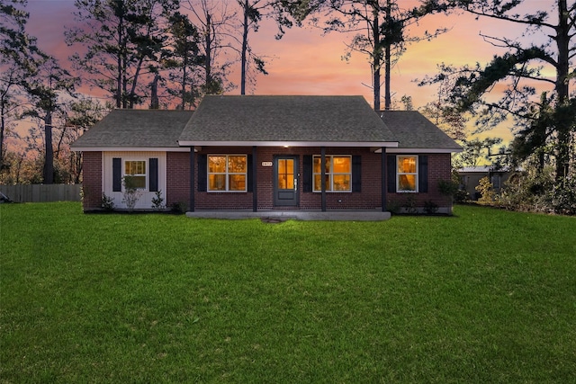 back house at dusk with a yard