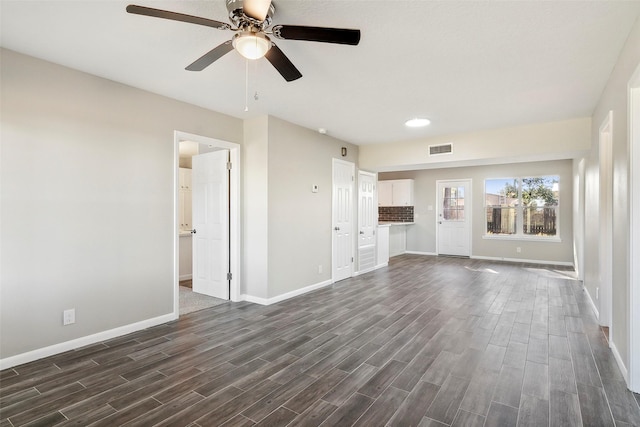 unfurnished living room featuring dark hardwood / wood-style flooring and ceiling fan