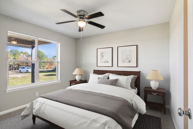 carpeted bedroom with ceiling fan and multiple windows