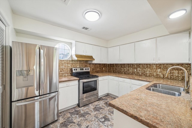 kitchen with appliances with stainless steel finishes, backsplash, light stone counters, sink, and white cabinetry