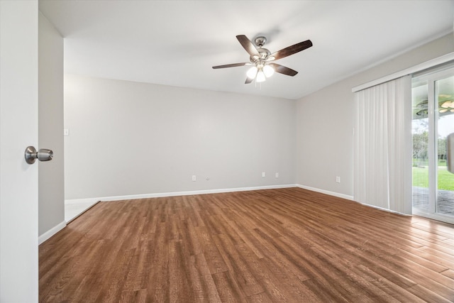 unfurnished room featuring ceiling fan, a healthy amount of sunlight, and dark wood-type flooring