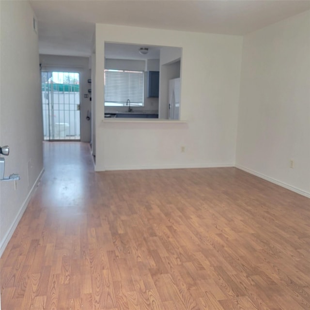 unfurnished living room with wood-type flooring