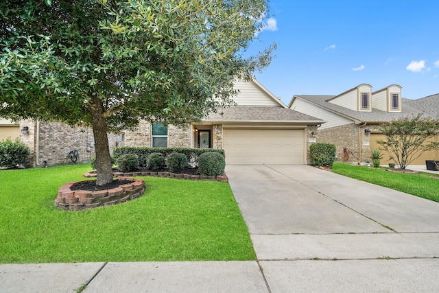 view of front of property with a front yard and a garage